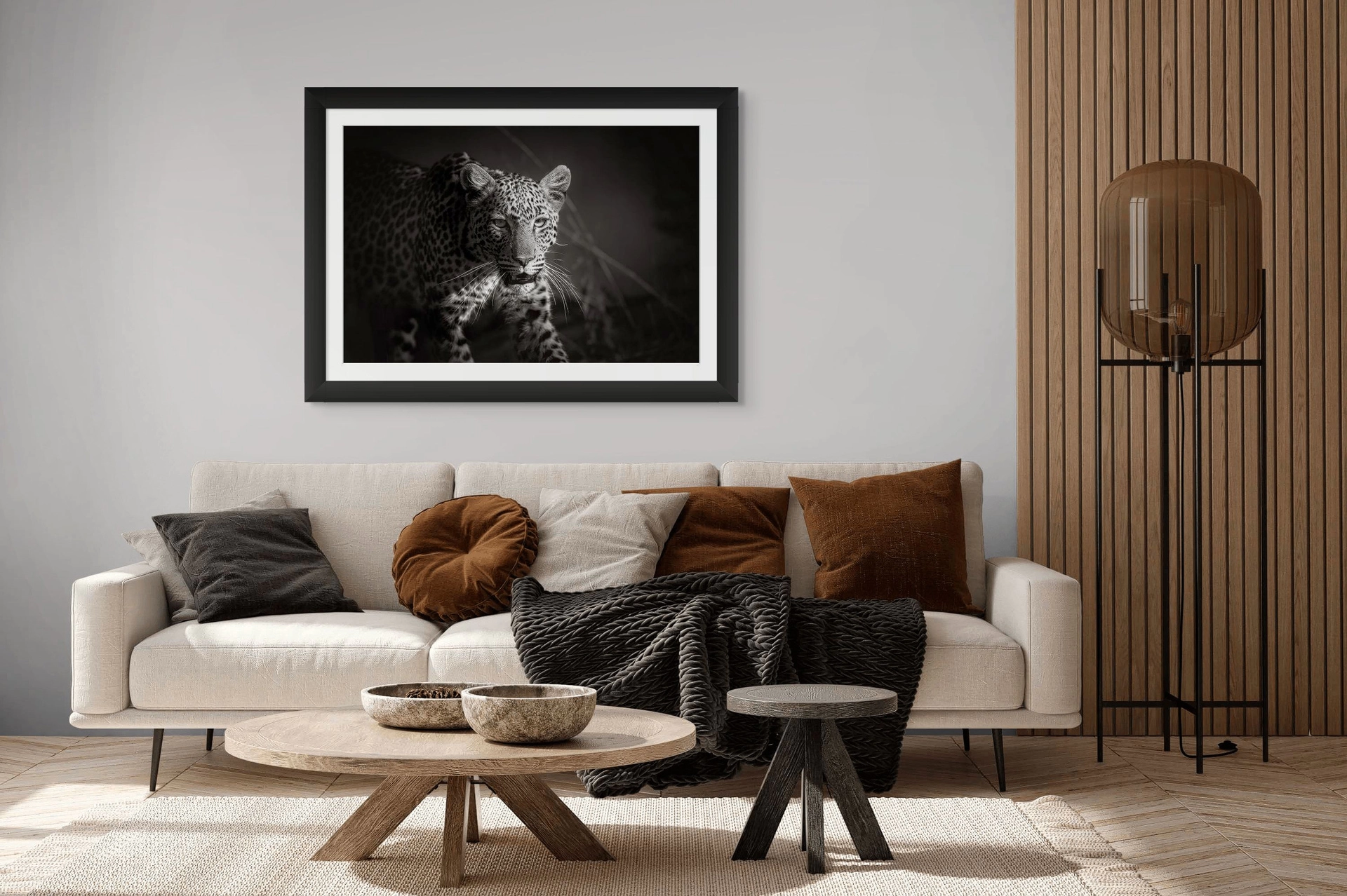 Black-and-white African wildlife photography of leopard framed as fine art print and displayed in a room